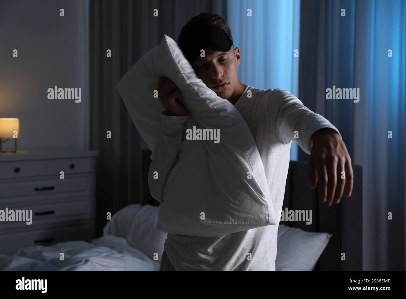 Young man suffering from sleepwalking at home Stock Photo