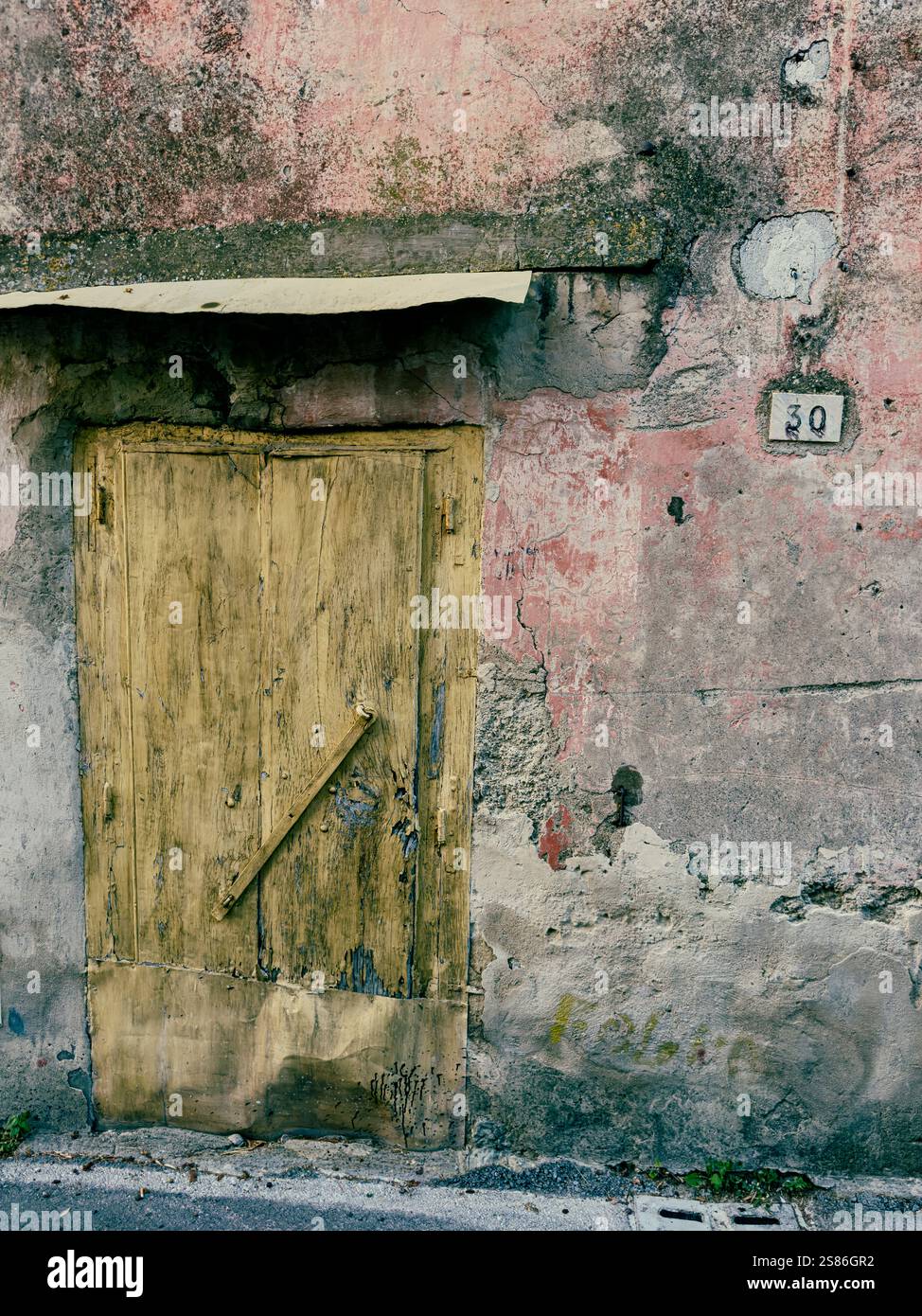 Textured exterior workshop wall in Vico Equense, Sorrento, Campania, Italy - Smartphone Captured Stock Image