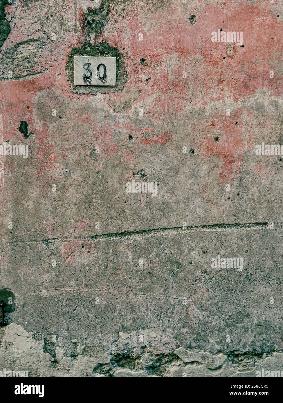 Detail of a Textured exterior workshop wall in Vico Equense, Sorrento, Campania, Italy - Smartphone Captured Stock Image