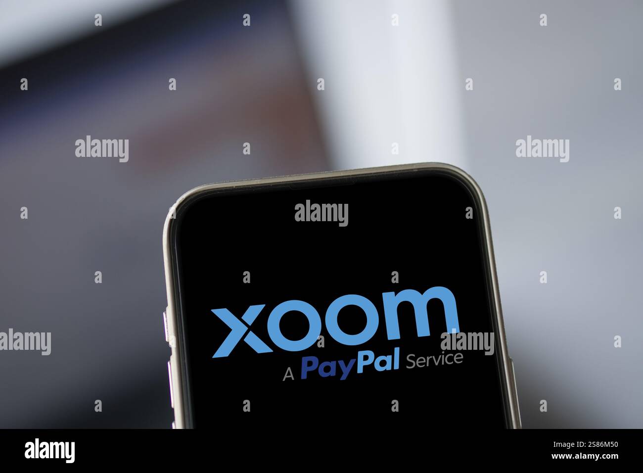 xoom logo is displayed on smartphone. Xoom Corporation is an electronic funds transfer and remittance provider Stock Photo