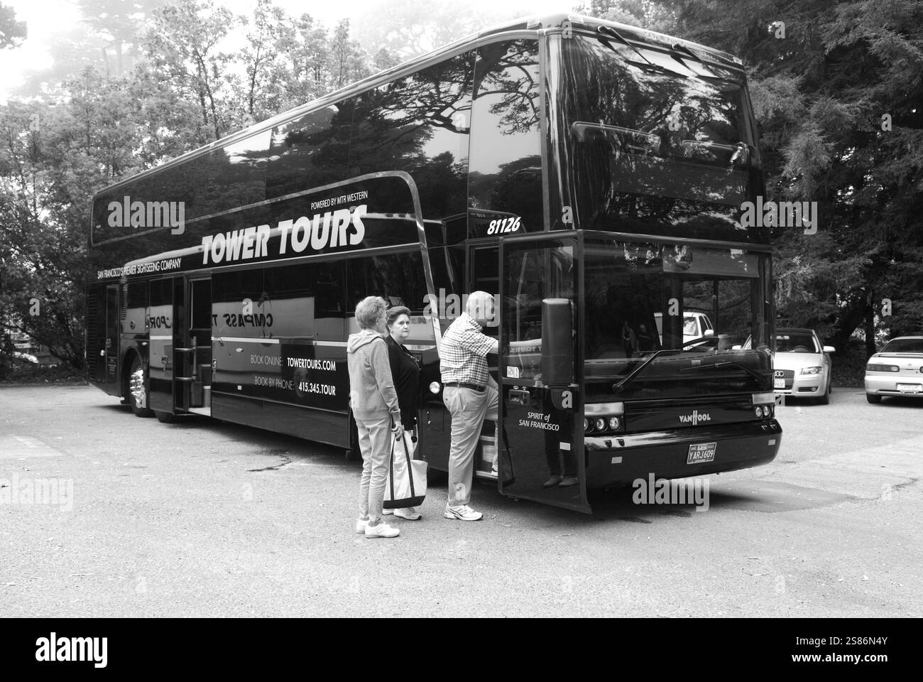 Tourists boarding a black double-decker tour bus in San Francisco, California, USA, ready to explore the city's iconic landmarks and attractions. Stock Photo