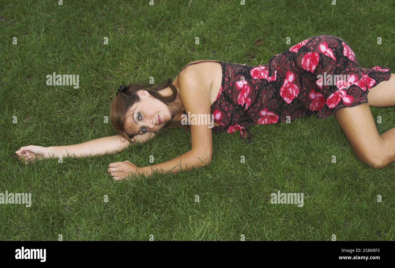 Brunette in red dress lies hi-res stock photography and images - Alamy
