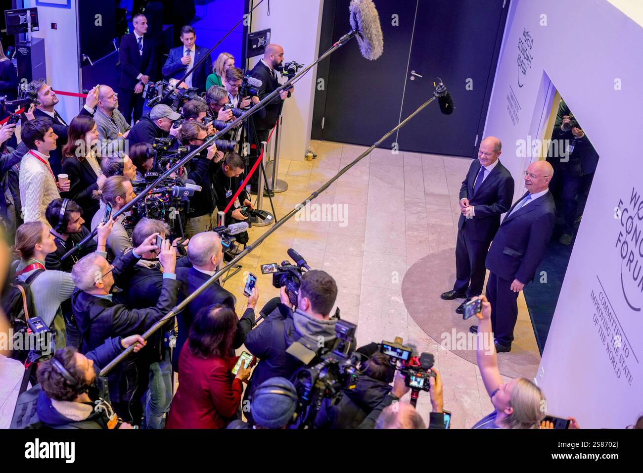 German Chancellor Olaf Scholz, left, and WEF founder Klaus Schwab meet