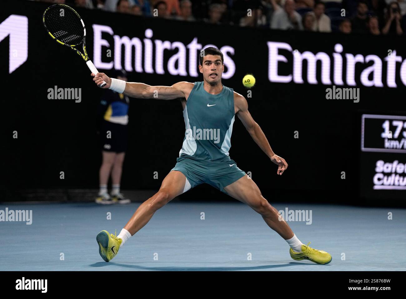 Carlos Alcaraz of Spain plays a forehand return to Novak Djokovic of