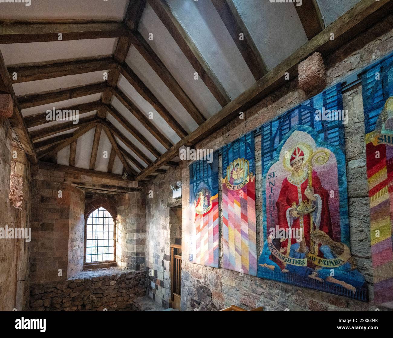 Wall hangings in a stairwell at Saint Nicholas Priory, the oldest building in Exeter, Devon, England, UK. Stock Photo