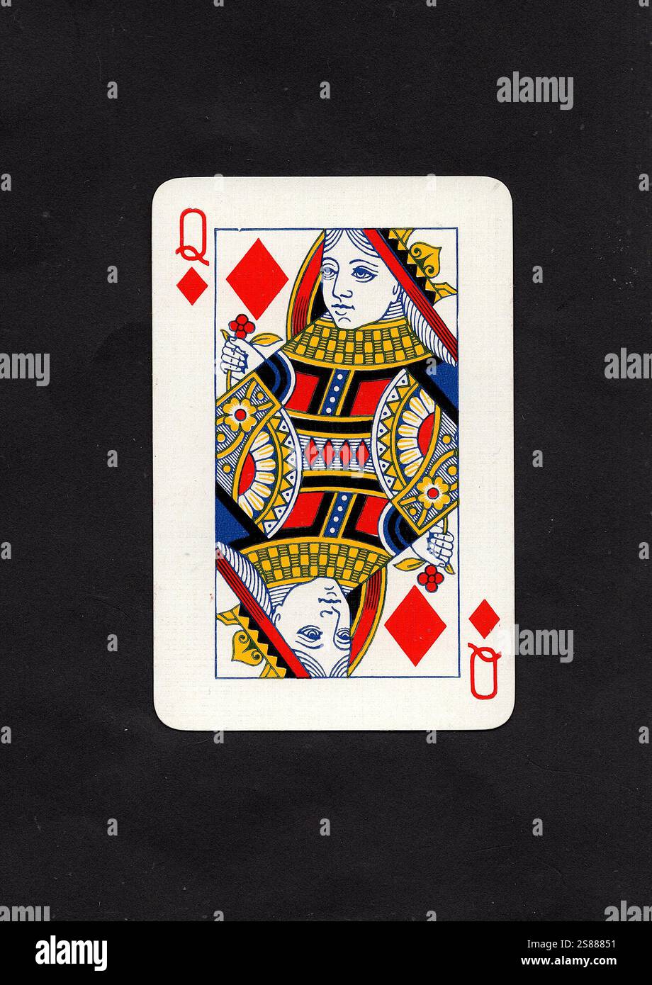 A vintage queen of diamonds playing card isolated on a black background ...