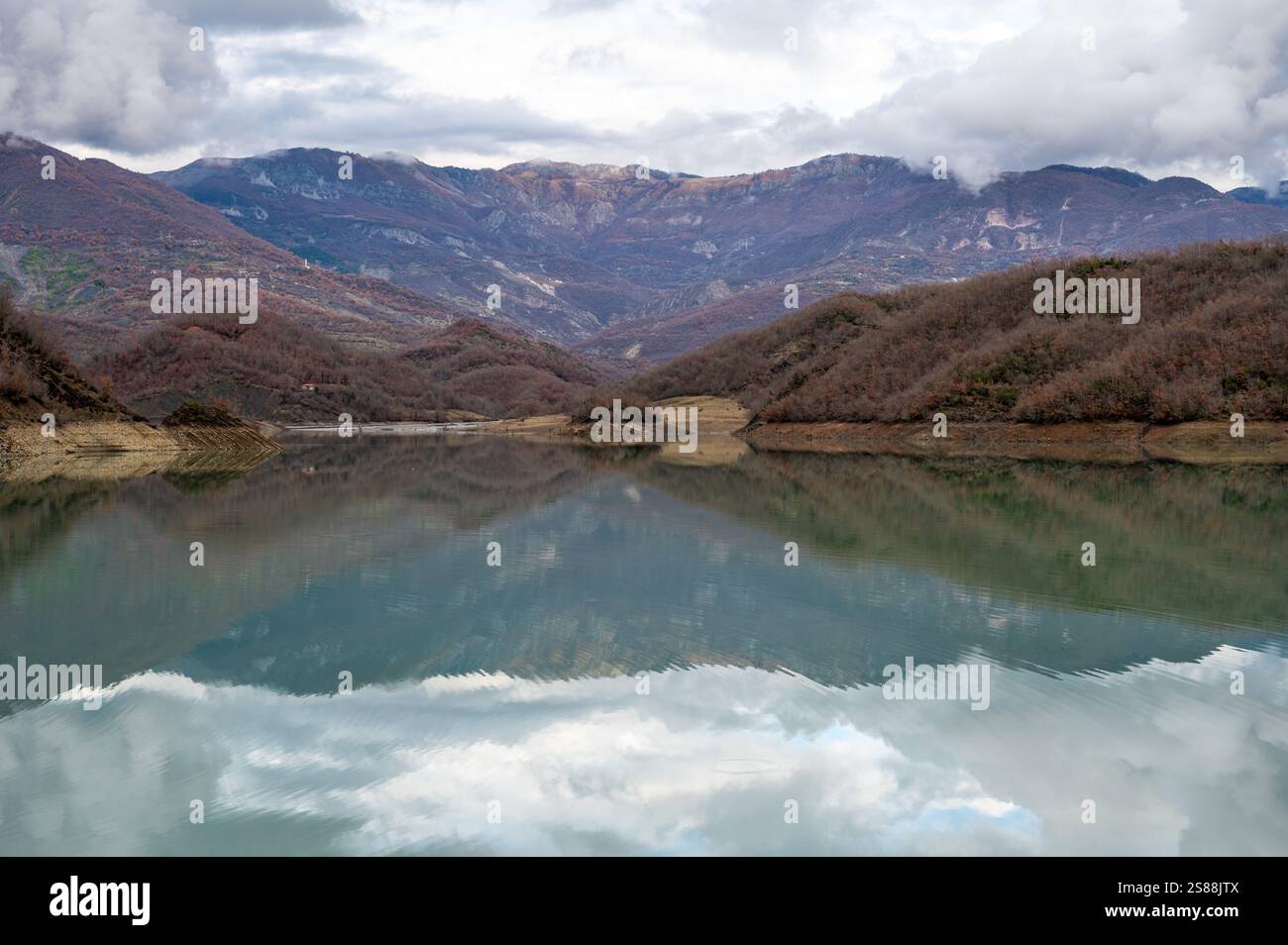Mountain reflections with autumn colors of woods in the Boivlla lake, Albania Stock Photo