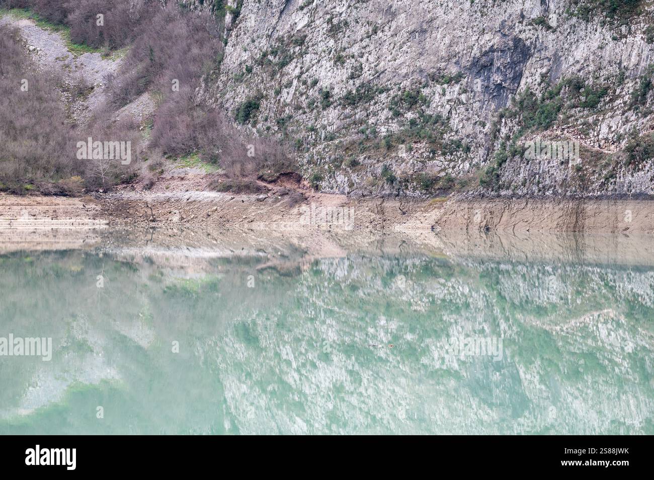 Mountain reflections with autumn colors of woods in the Boivlla lake, Albania Stock Photo