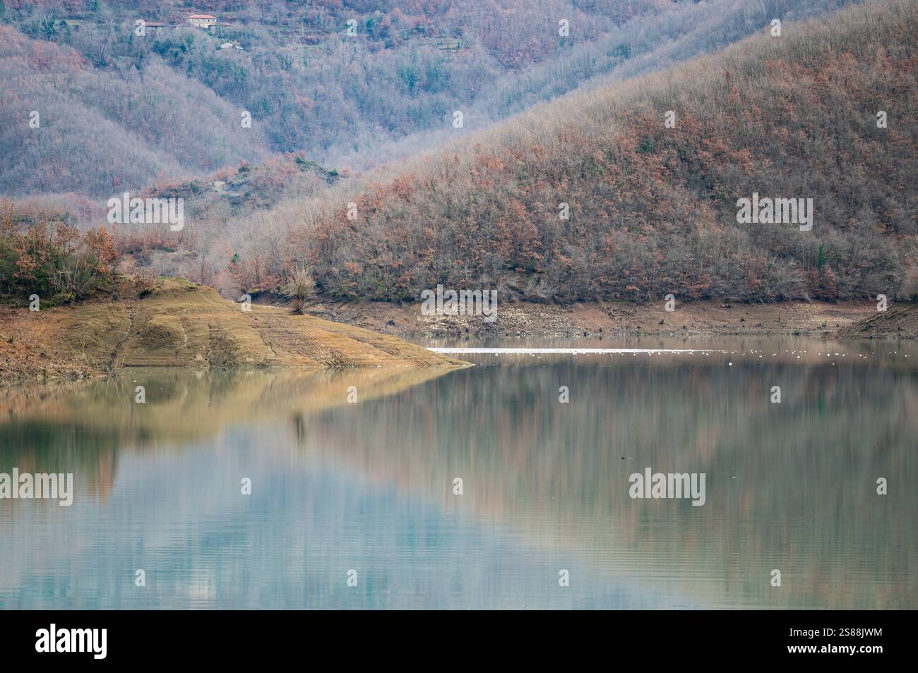 Mountain reflections with autumn colors of woods in the Boivlla lake, Albania Stock Photo
