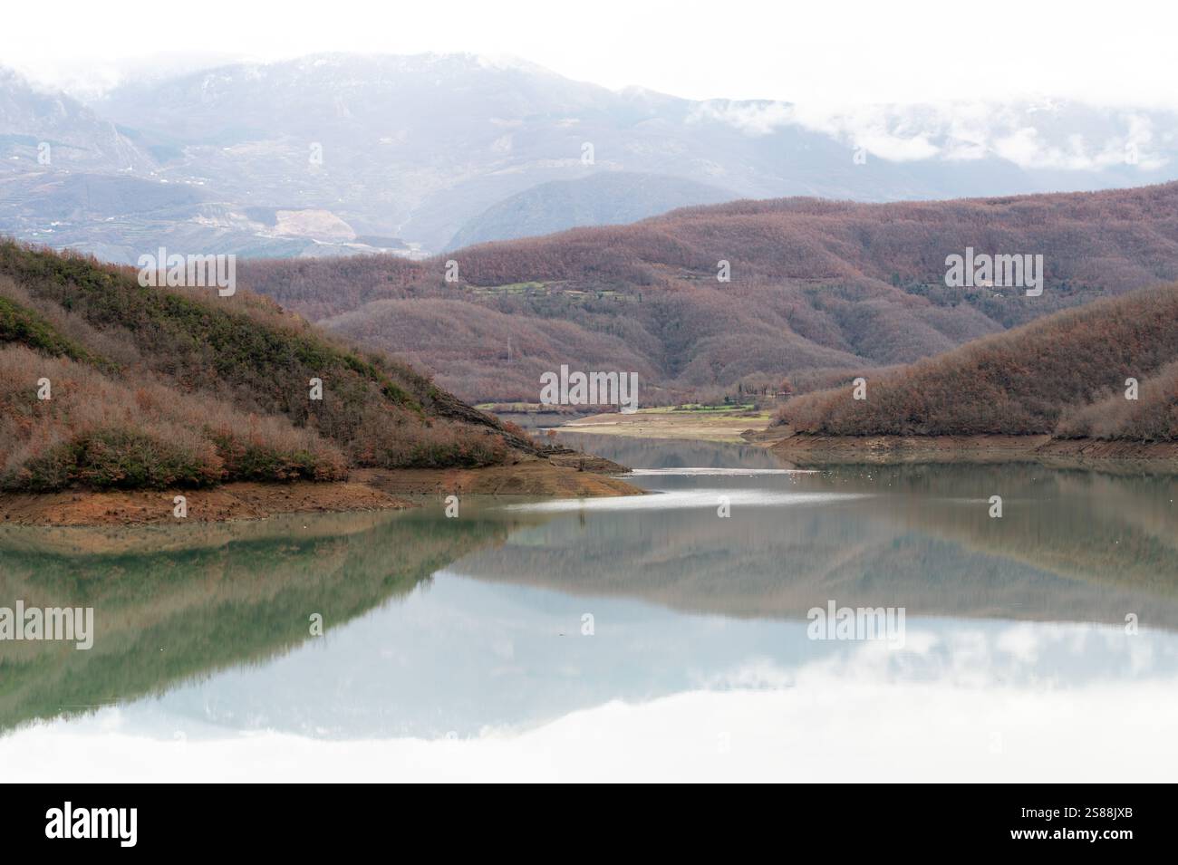 Mountain reflections with autumn colors of woods in the Boivlla lake, Albania Stock Photo