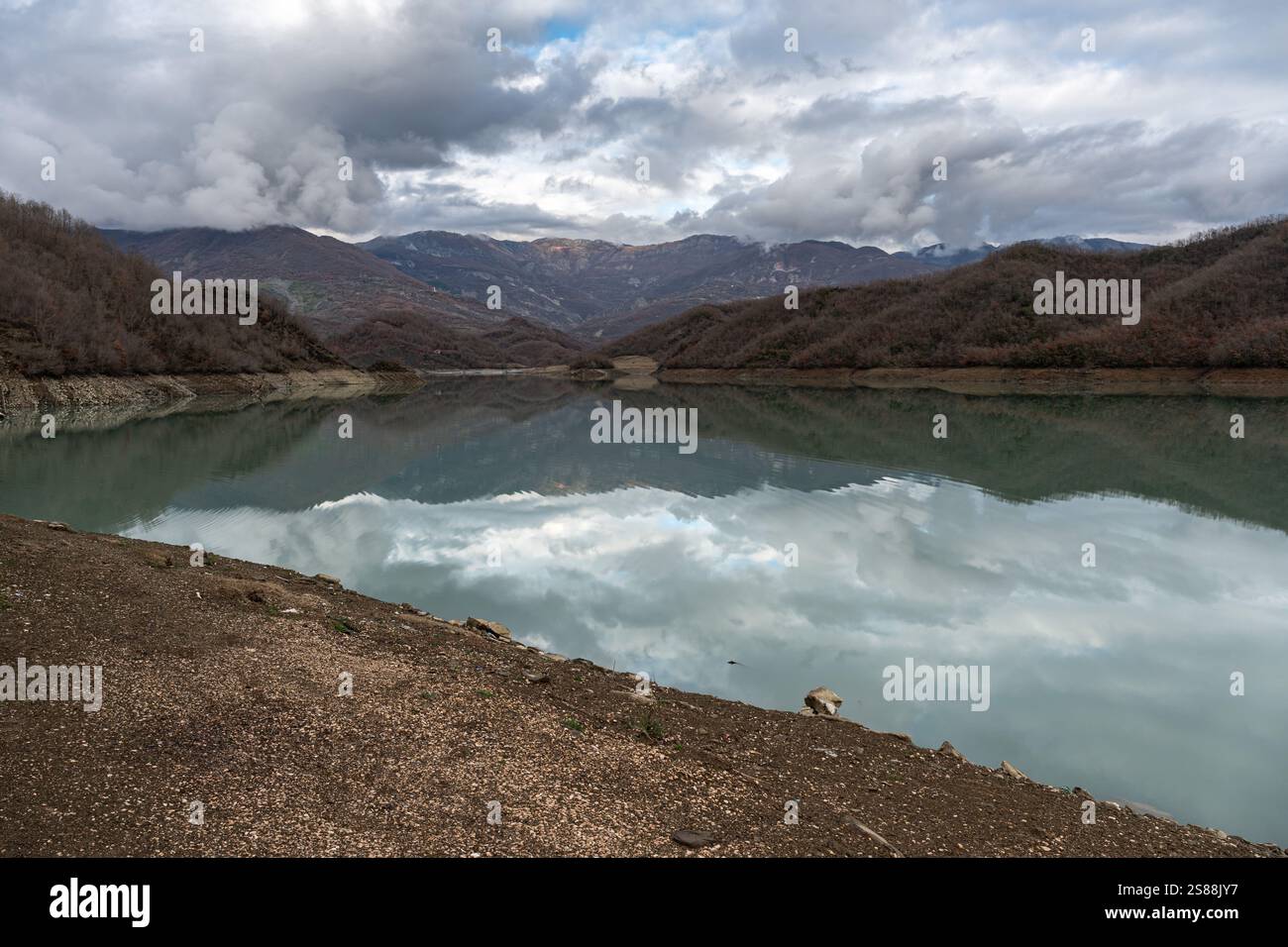 Mountain reflections with autumn colors of woods in the Boivlla lake, Albania Stock Photo