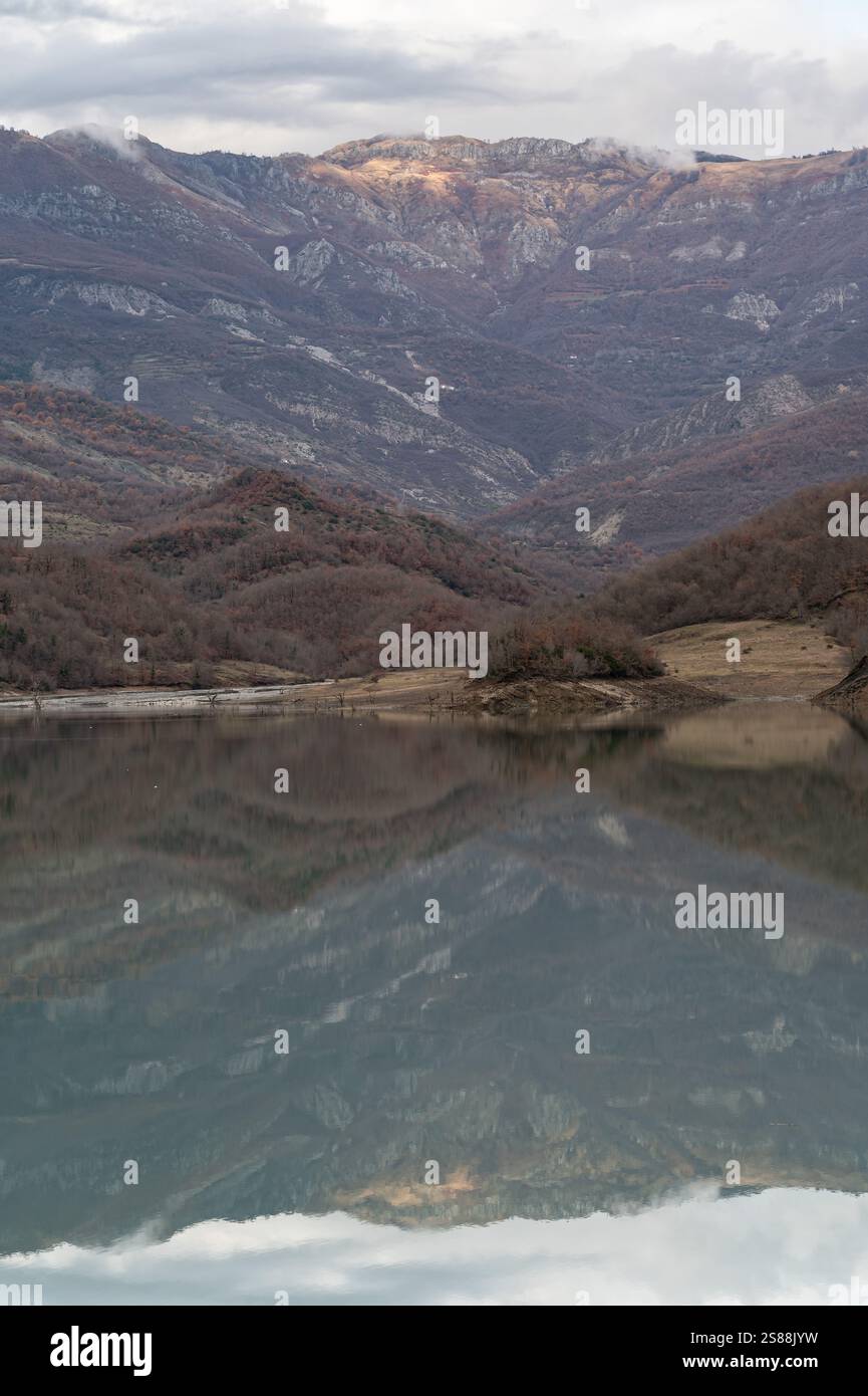 Mountain reflections with autumn colors of woods in the Boivlla lake, Albania Stock Photo