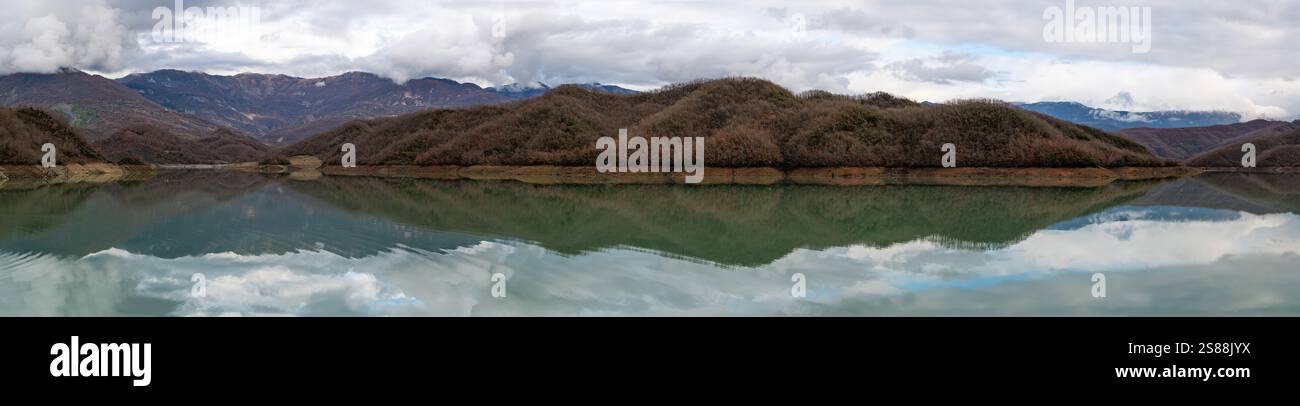 Mountain reflections with autumn colors of woods in the Boivlla lake, Albania Stock Photo