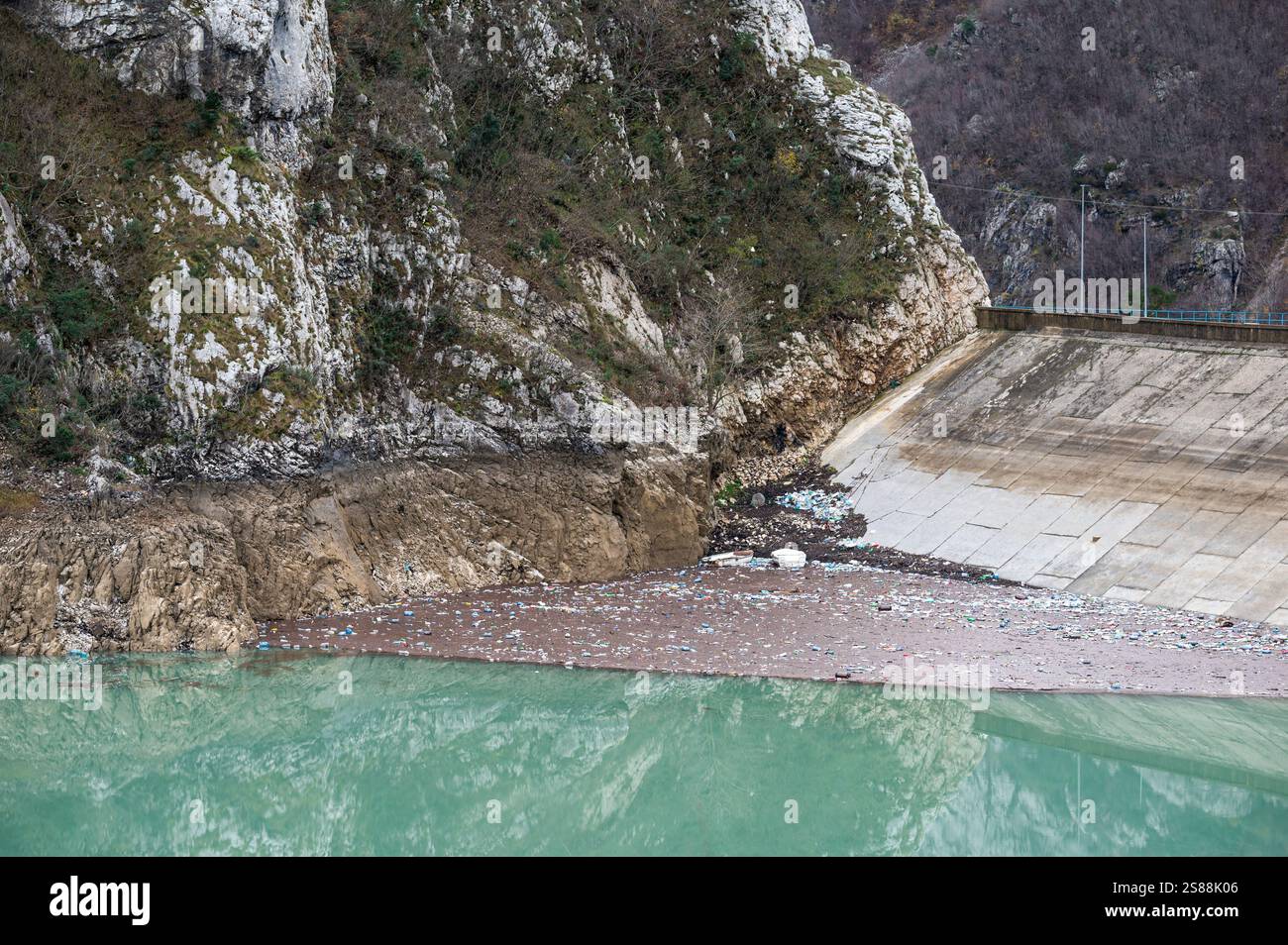 Dirty and debris floating in the Bovilla lake at the dam, Albania Stock Photo
