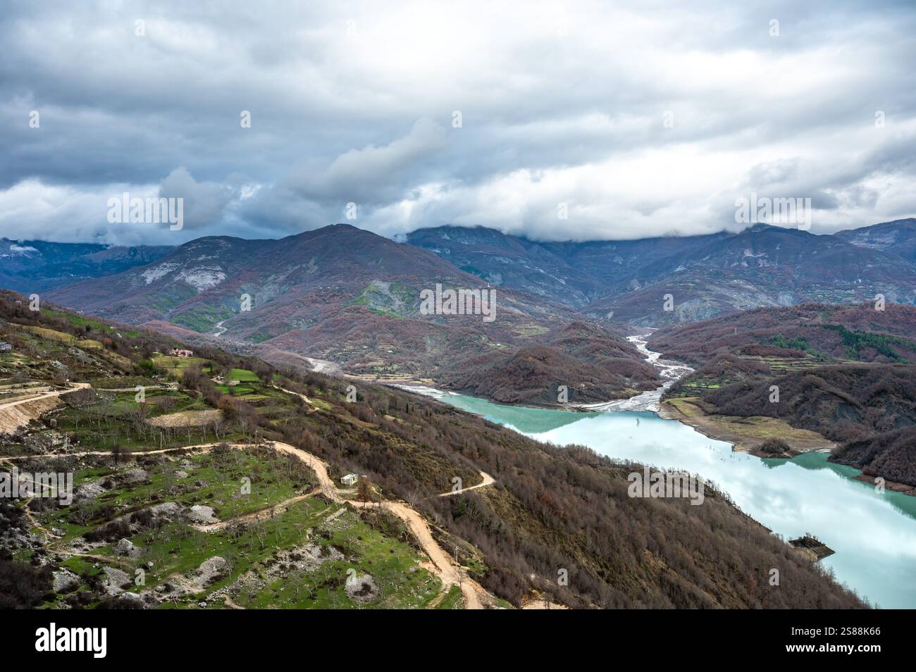 High angle view over the Gamti Mountain and Bovilla lake in Albania. Grey and green rock formation with blue water of the artificial lake with mountai Stock Photo