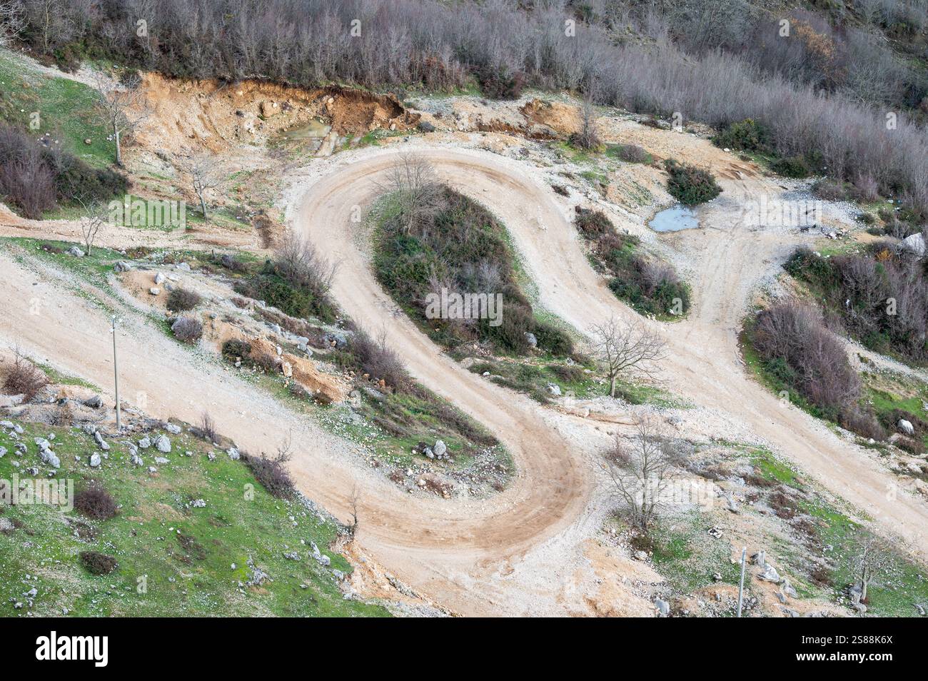 Swirling gravel road for hiking at the Gamti mountain near Bovilla lake, Albania Stock Photo
