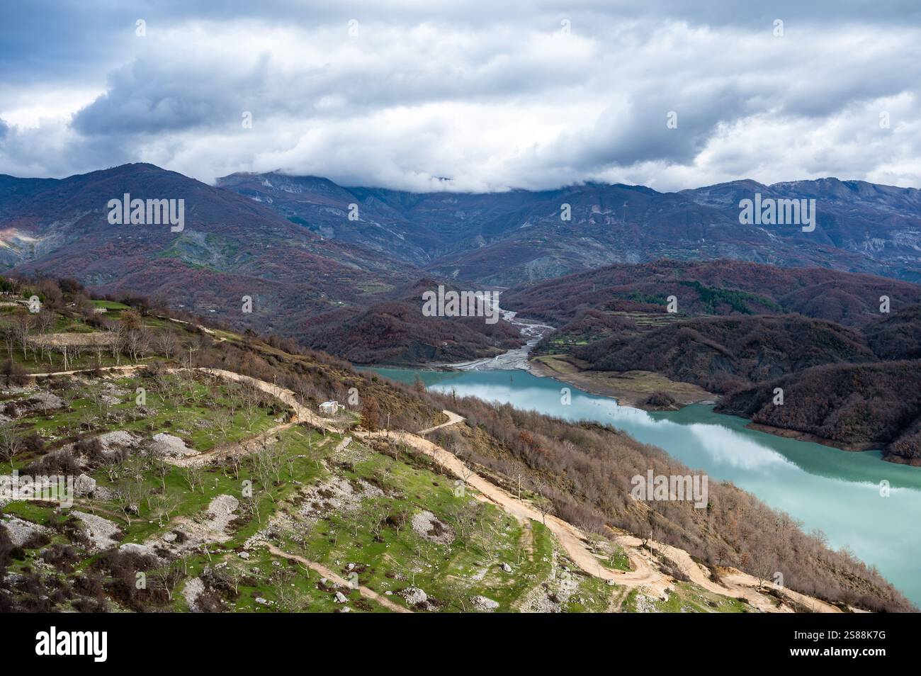 High angle view over the Gamti Mountain and Bovilla lake in Albania. Grey and green rock formation with blue water of the artificial lake with mountai Stock Photo