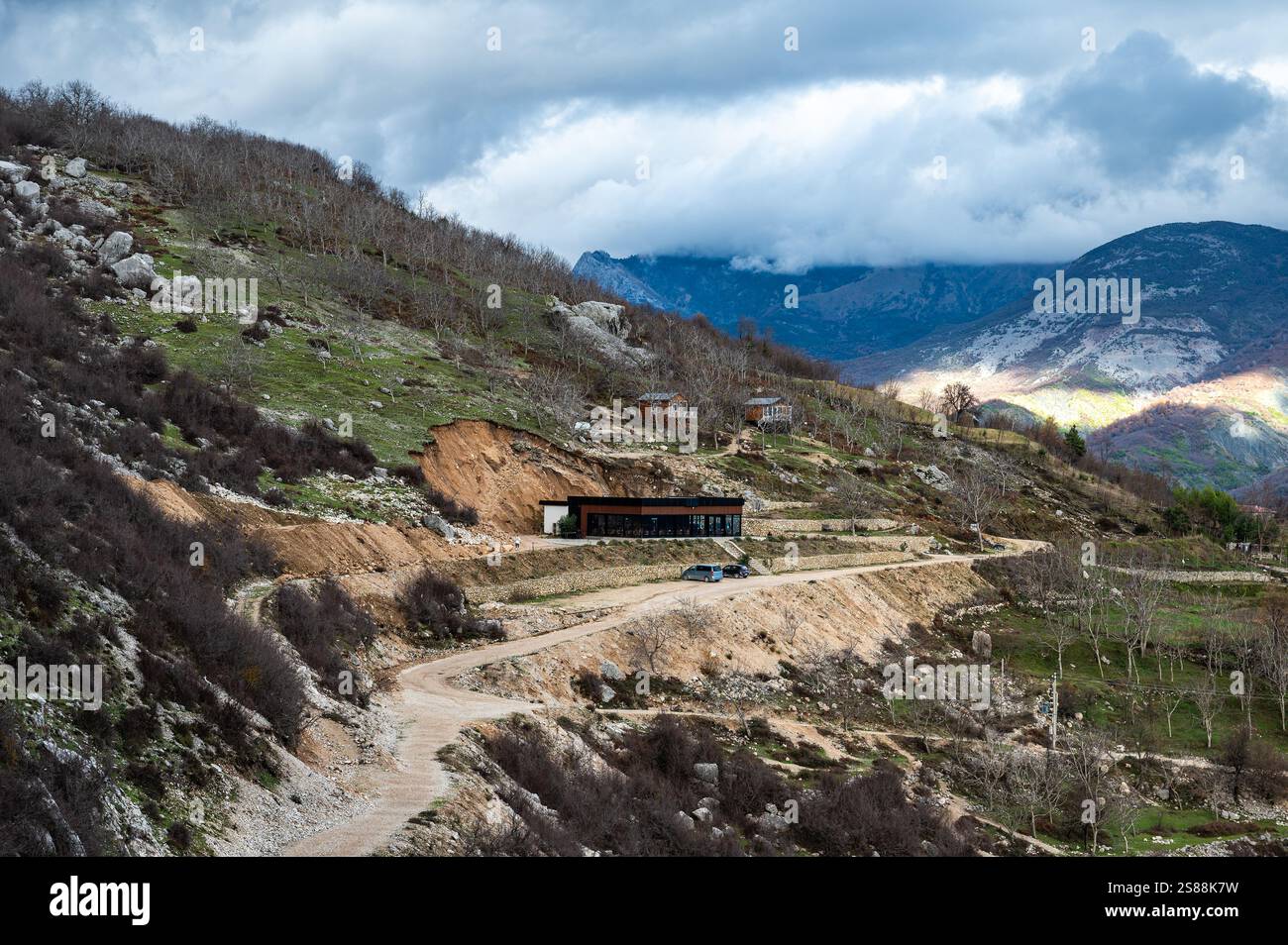 Dirty gravel road at Gamti Mountain near the artificial Bovilla Lake towards the restaurant, Albania Stock Photo