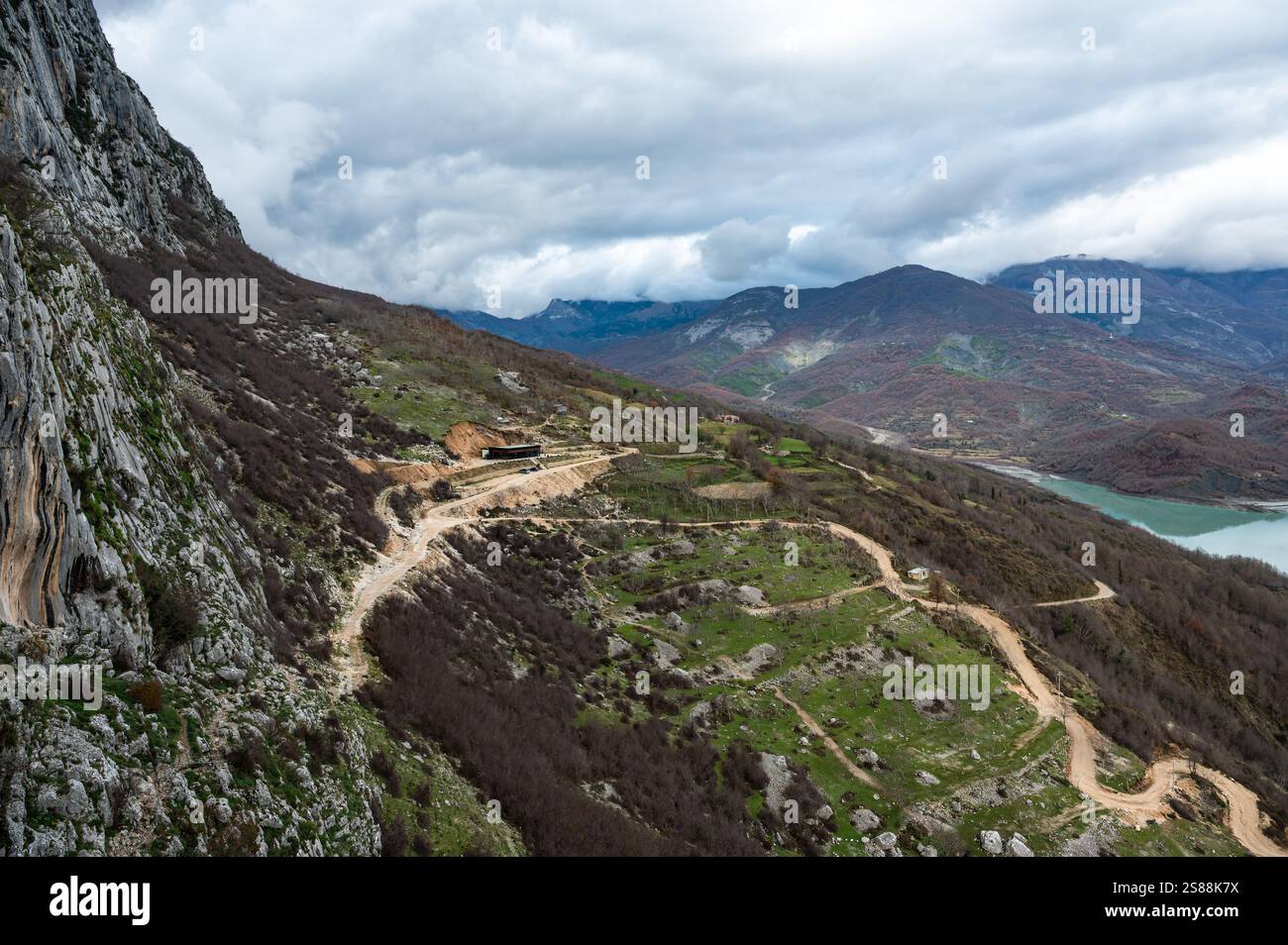 Dirty gravel road at Gamti Mountain near the artificial Bovilla Lake towards the restaurant, Albania Stock Photo