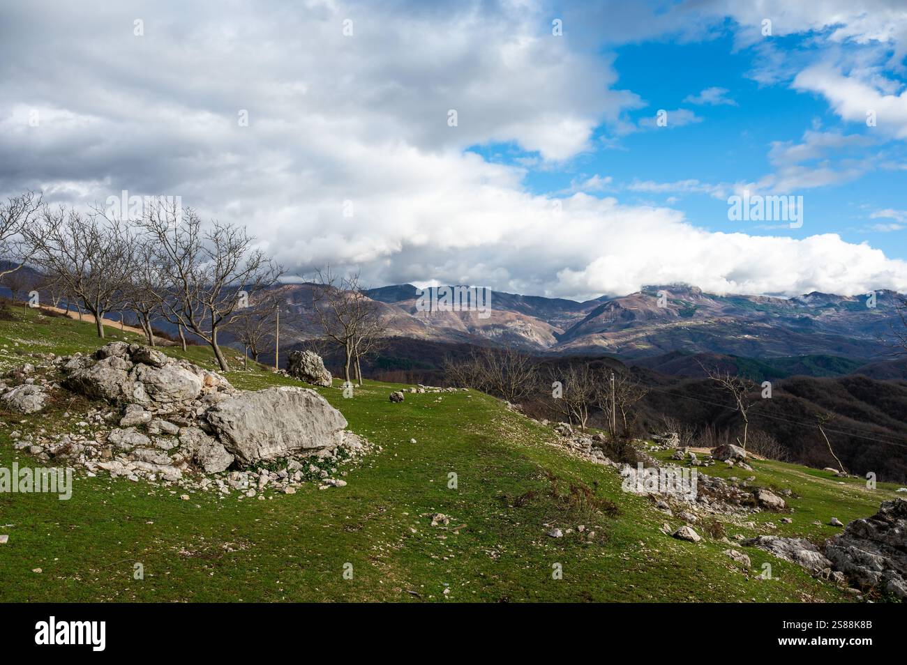 Fallen stone and rock formation with a mountain background at Gamti Mountain, Albania Stock Photo