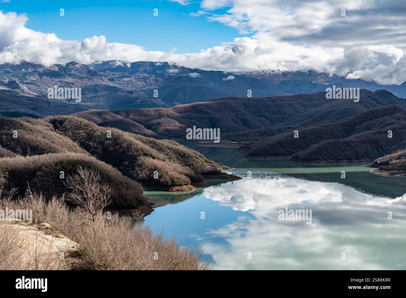 High angle view over the Gamti Mountain and Bovilla lake in Albania. Grey and green rock formation with blue water of the artificial lake with mountai Stock Photo
