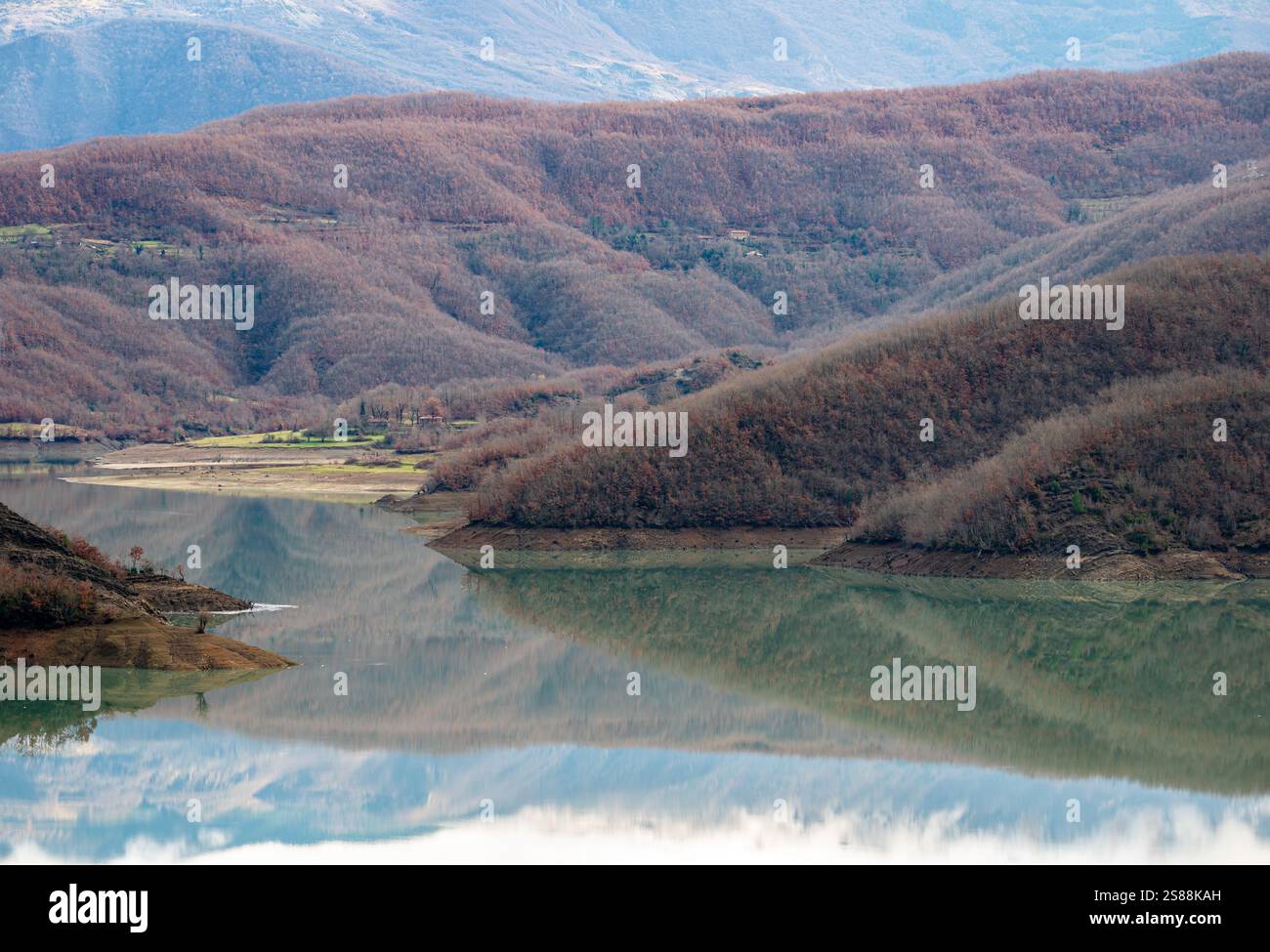 Mountain reflections with autumn colors of woods in the Boivlla lake, Albania Stock Photo