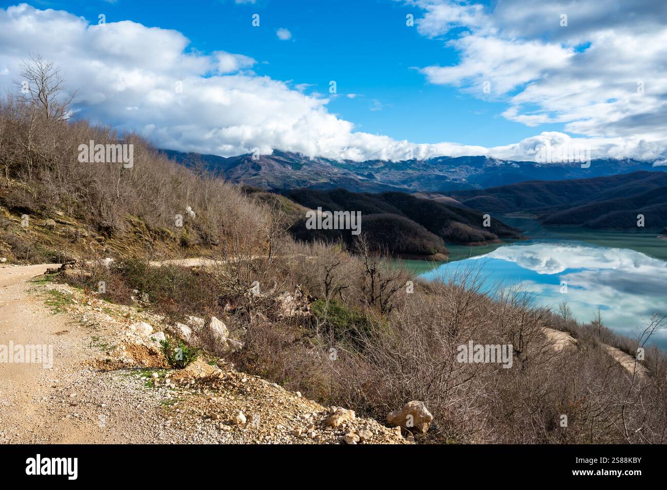 High angle view over the Gamti Mountain and Bovilla lake in Albania. Grey and green rock formation with blue water of the artificial lake with mountai Stock Photo