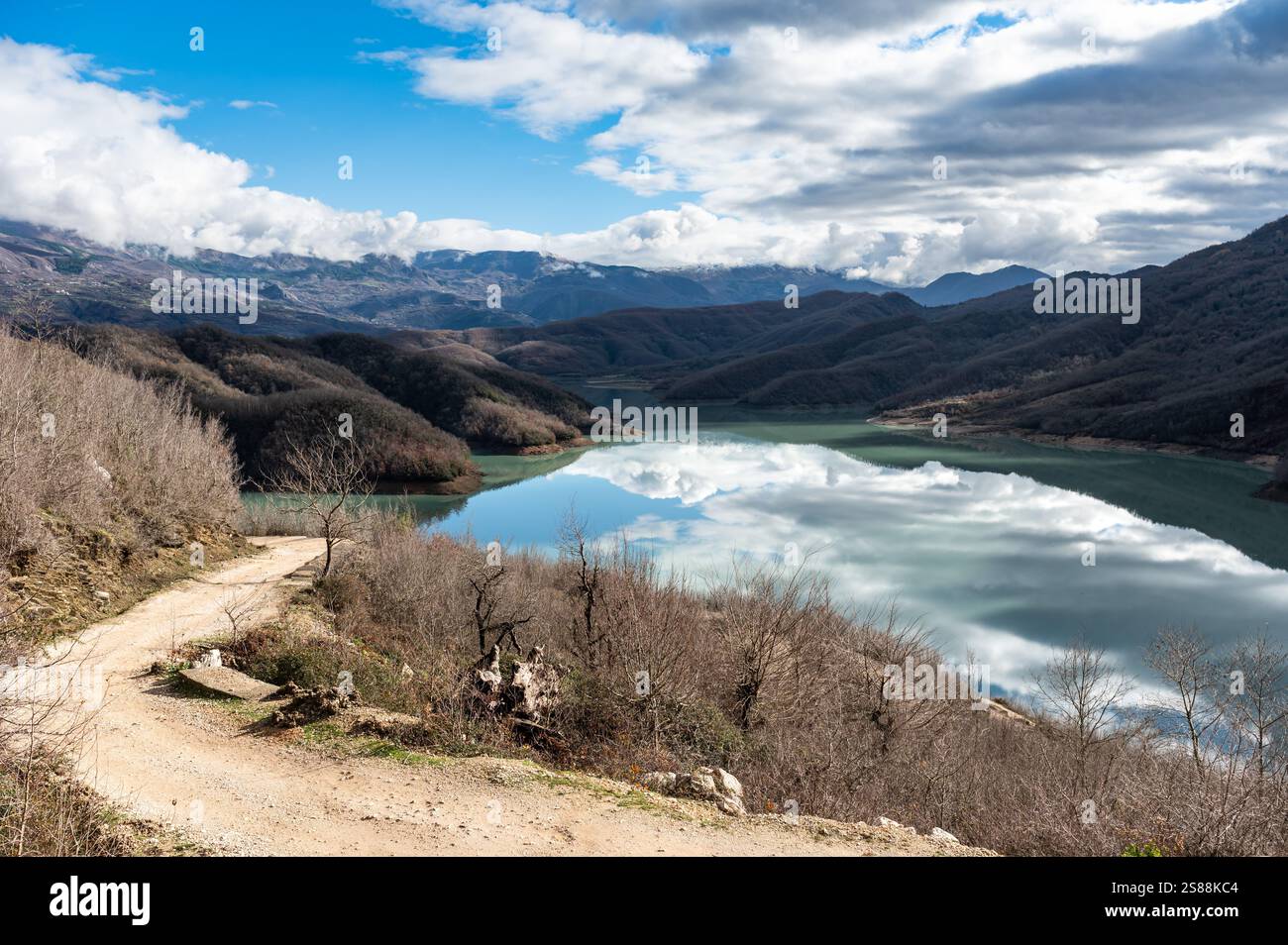 High angle view over the Gamti Mountain and Bovilla lake in Albania. Grey and green rock formation with blue water of the artificial lake with mountai Stock Photo