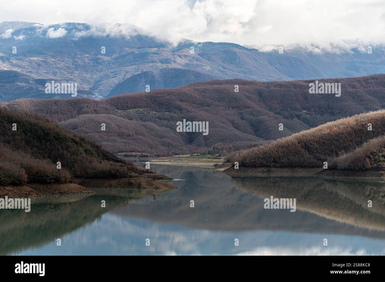 Mountain reflections with autumn colors of woods in the Boivlla lake, Albania Stock Photo