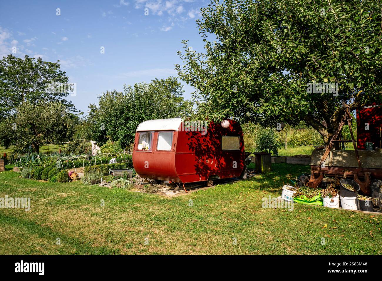 Allotment garden with old caravan and vegetable patches Stock Photo