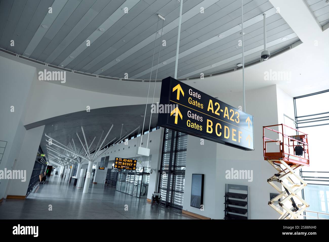 Interior of a Modern Airport Terminal with Departure Signs Stock Photo