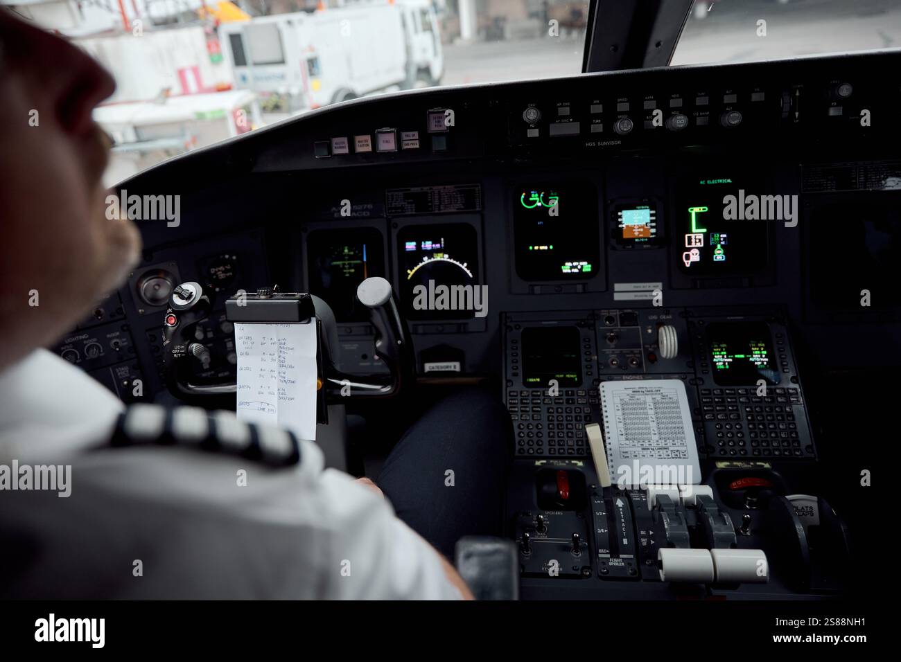 Commercial Pilot in Aircraft Cockpit Preparing for Takeoff at the Airport Stock Photo