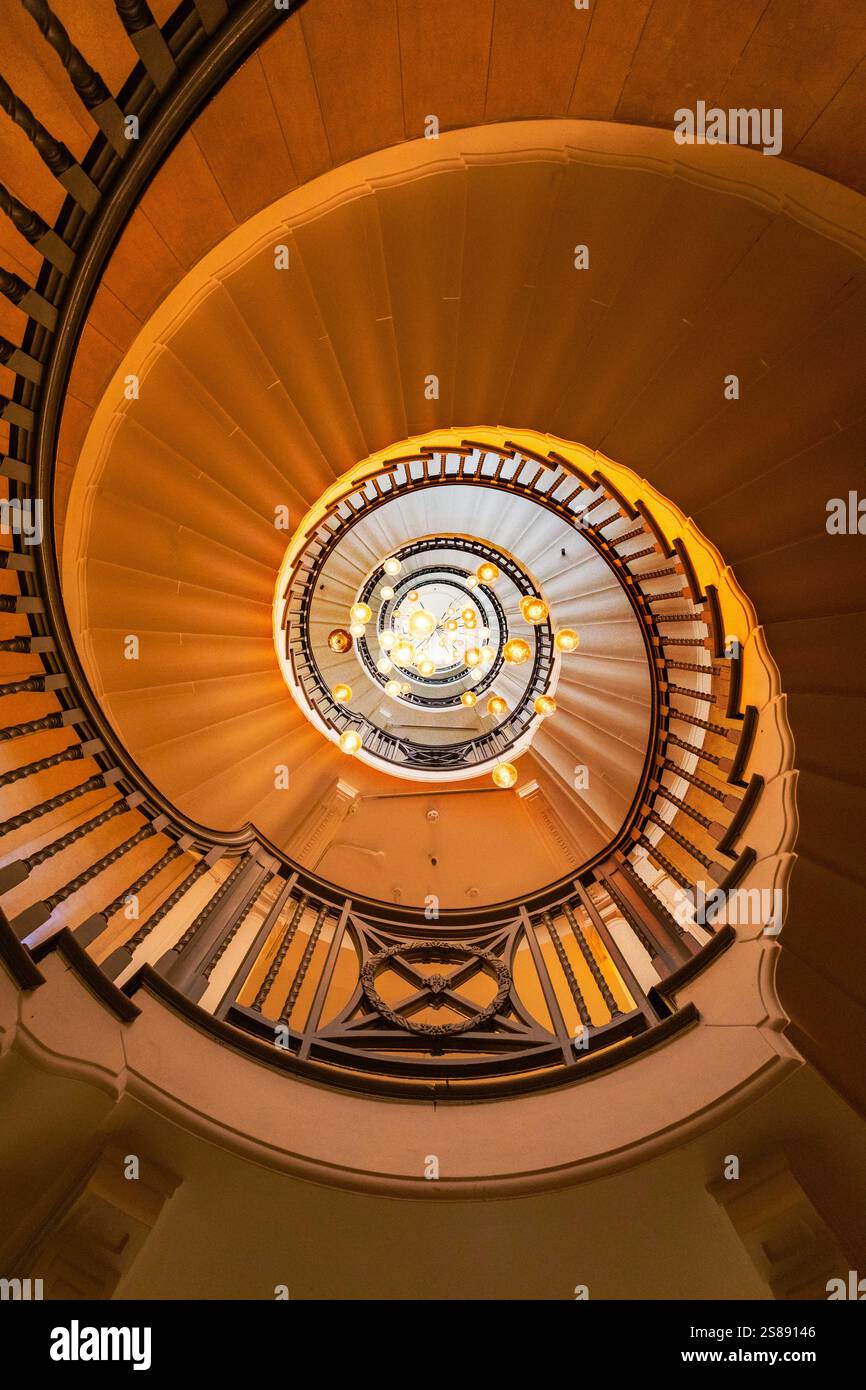 Spiral staircase, ornate railing, light fixtures Stock Photo - Alamy
