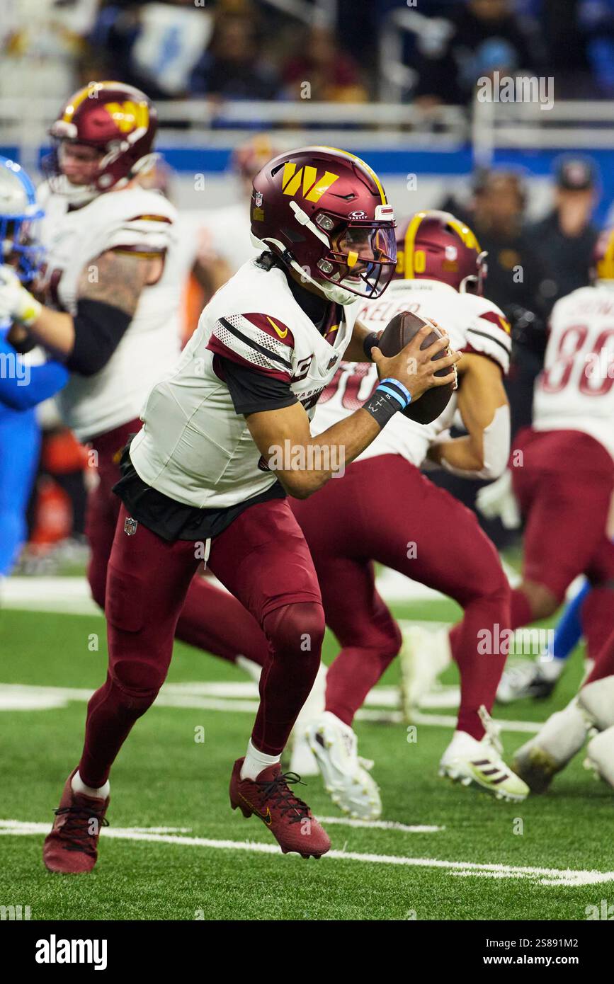 Washington Commanders quarterback Jayden Daniels (5) rolls out to pass