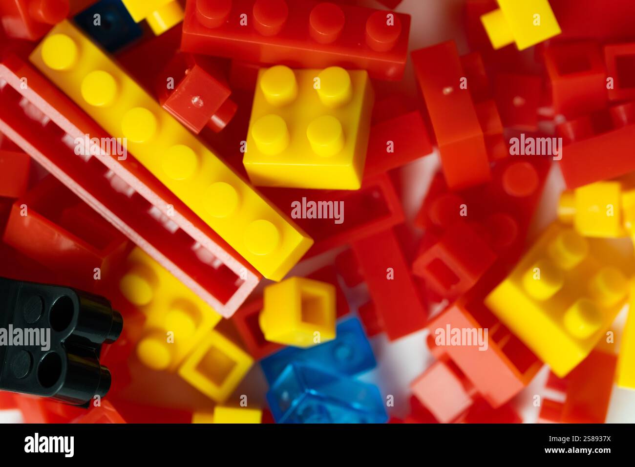 Plastic building blocks on white background. Closeup Stock Photo