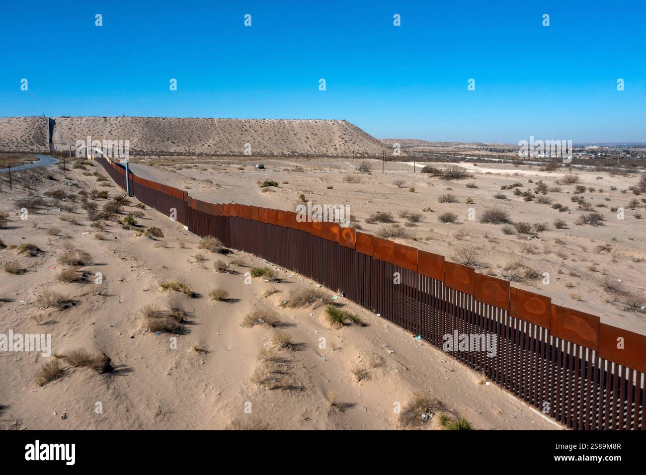 The border wall between Mexico, left, and the United States is pictured ...