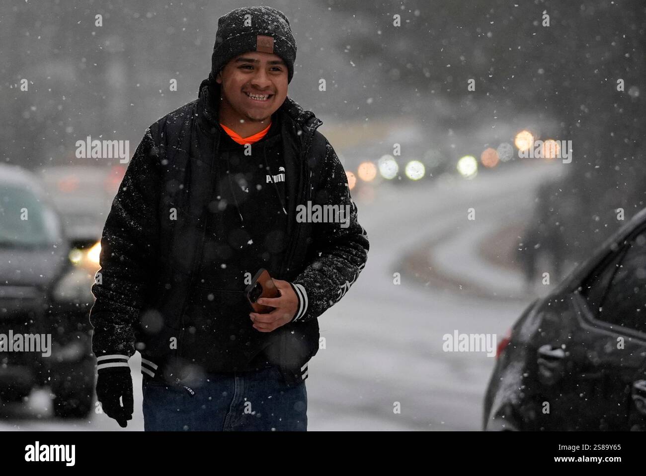 A person walks in the snow during a winter storm on Tuesday, Jan. 21