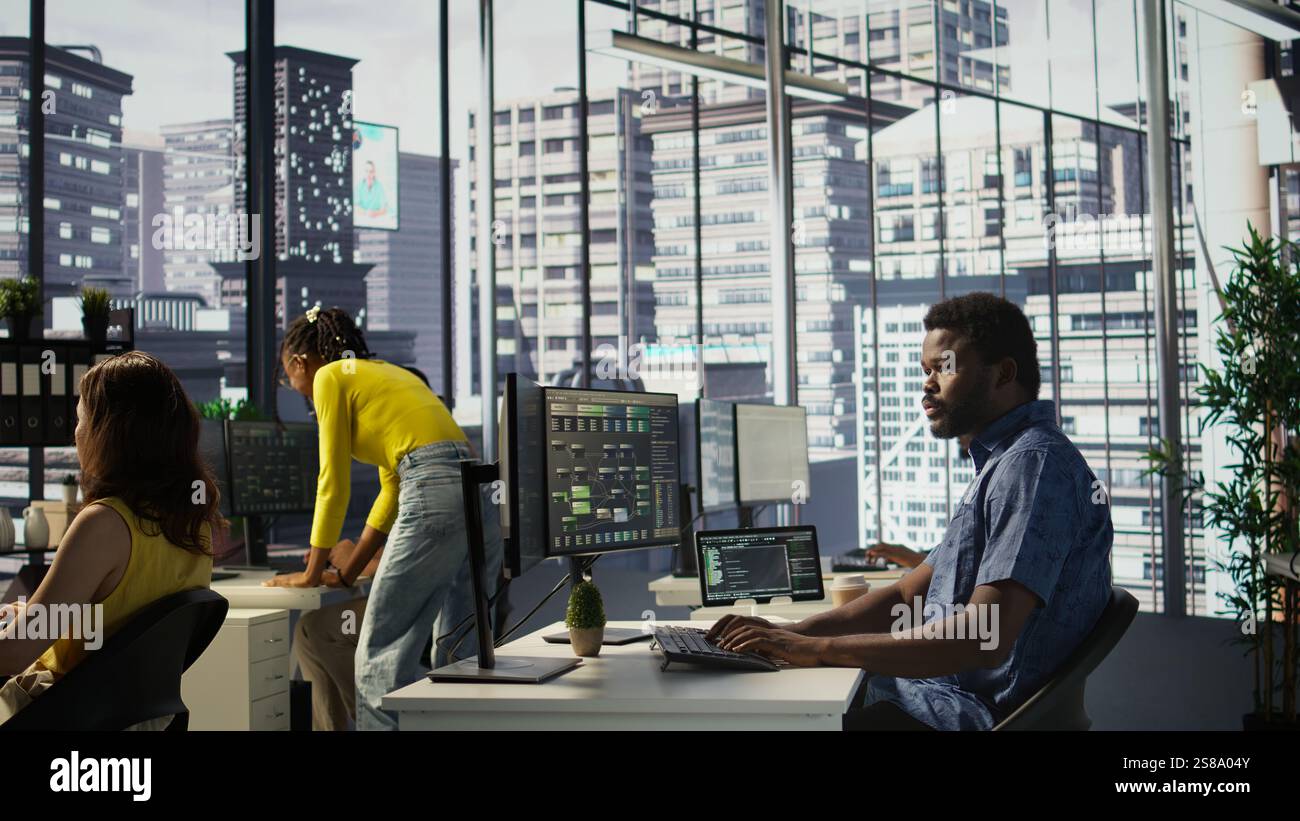 Computer scientist resuming work after strolling in workspace, doing software debugging using PC. Man walking with tablet in office, fixing coding issues using computer, camera B Stock Photo