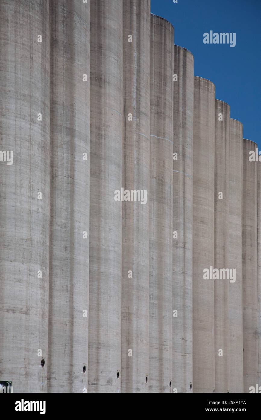 Abstract architectural view of tall concrete grain elevator towers on ...