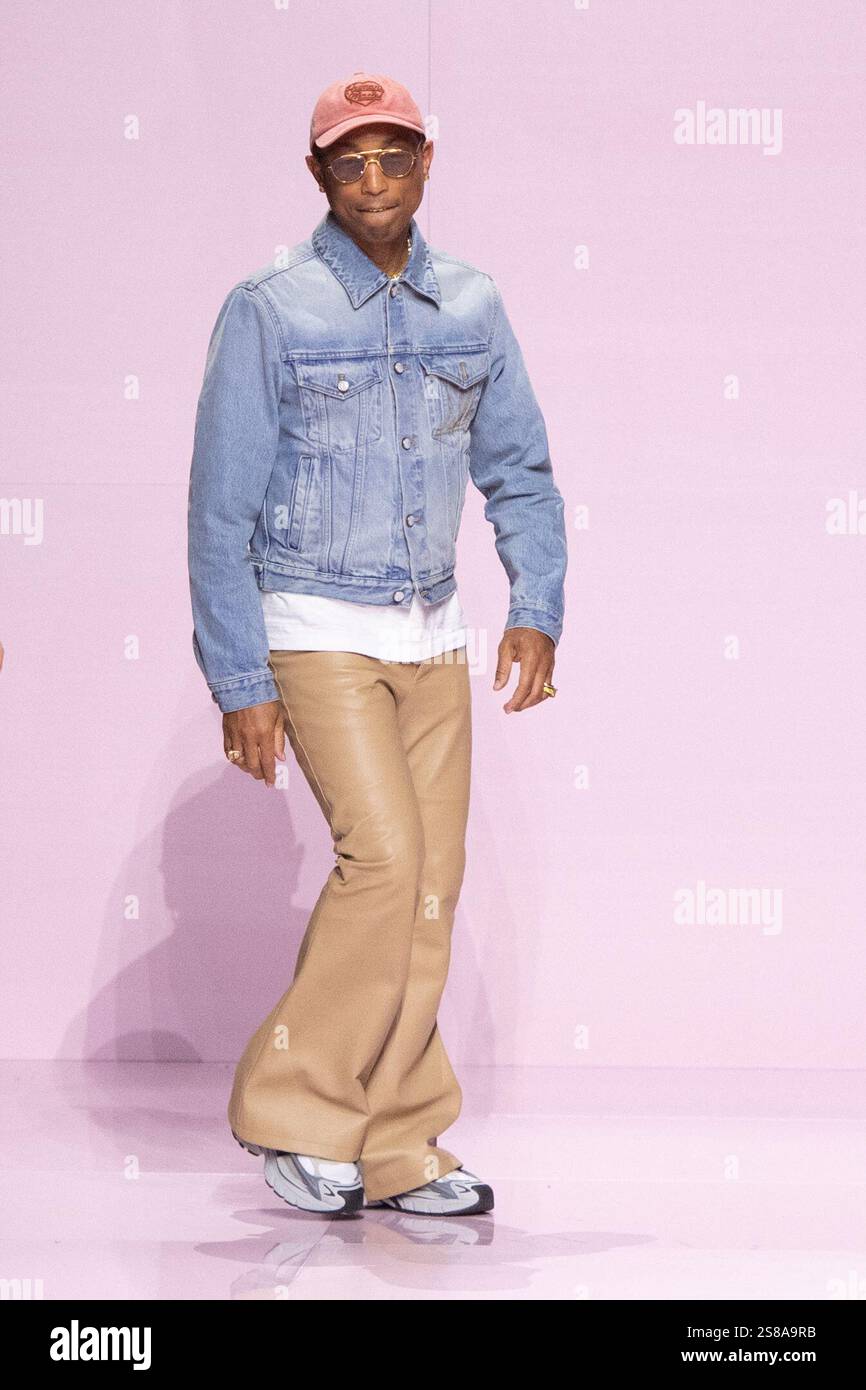 Designer Pharrell Williams makes an appearance on the runway during the