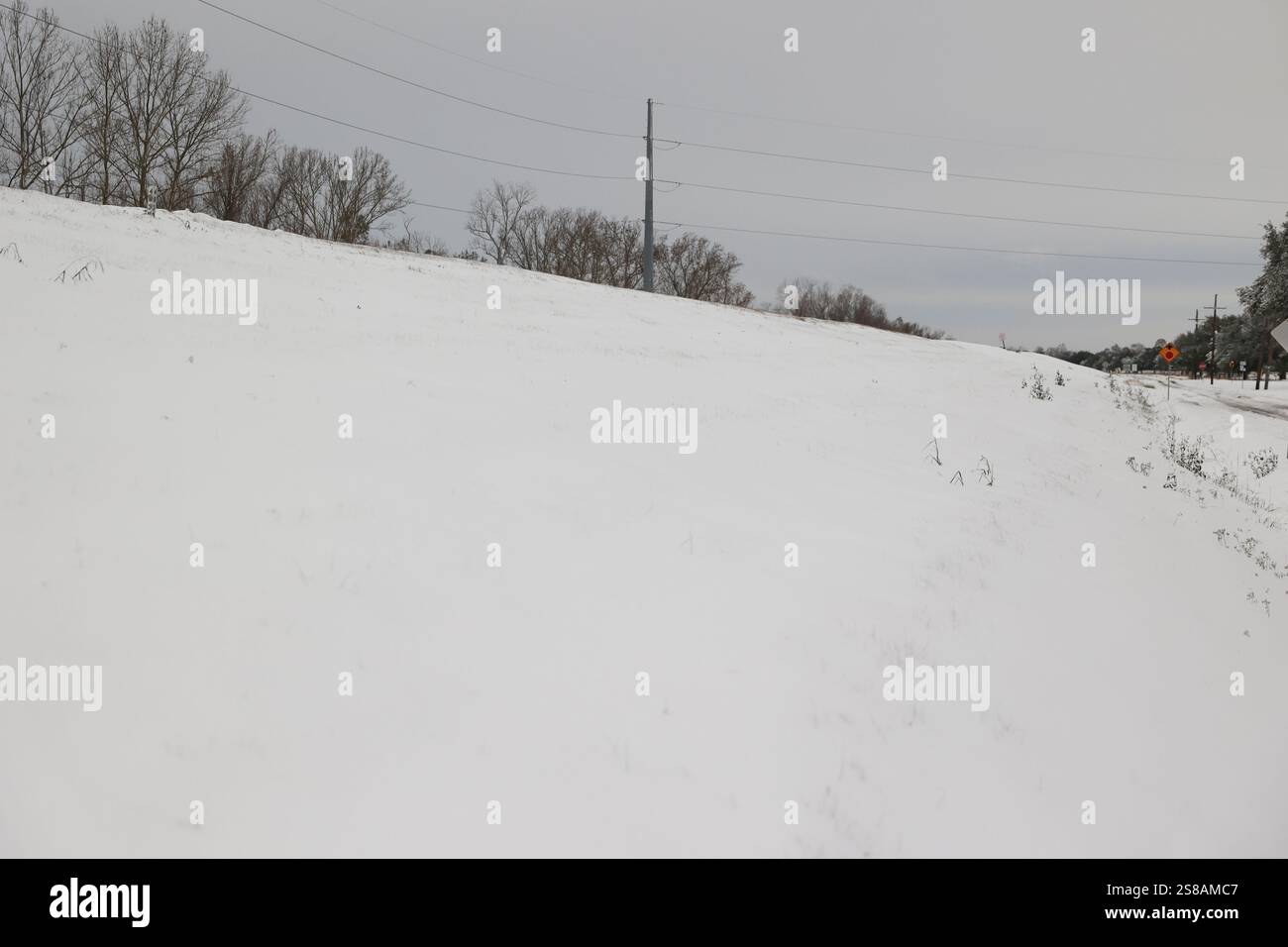 Snowfall from Winter Storm Enzo cover the levee and River Road on