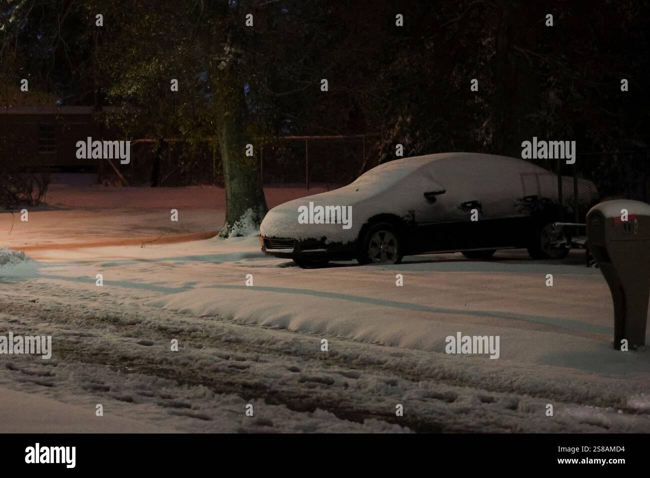 Snowfall from Winter Storm Enzo cover Apricot Street and a car on
