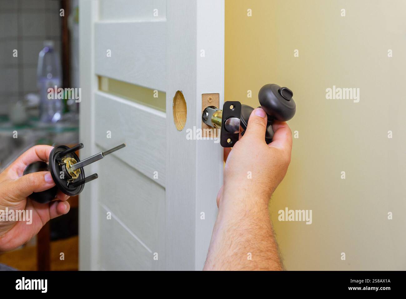 Handyman installs new doorknob, lockset on white interior door in ... - Apartment Lockset Installation For Renovation