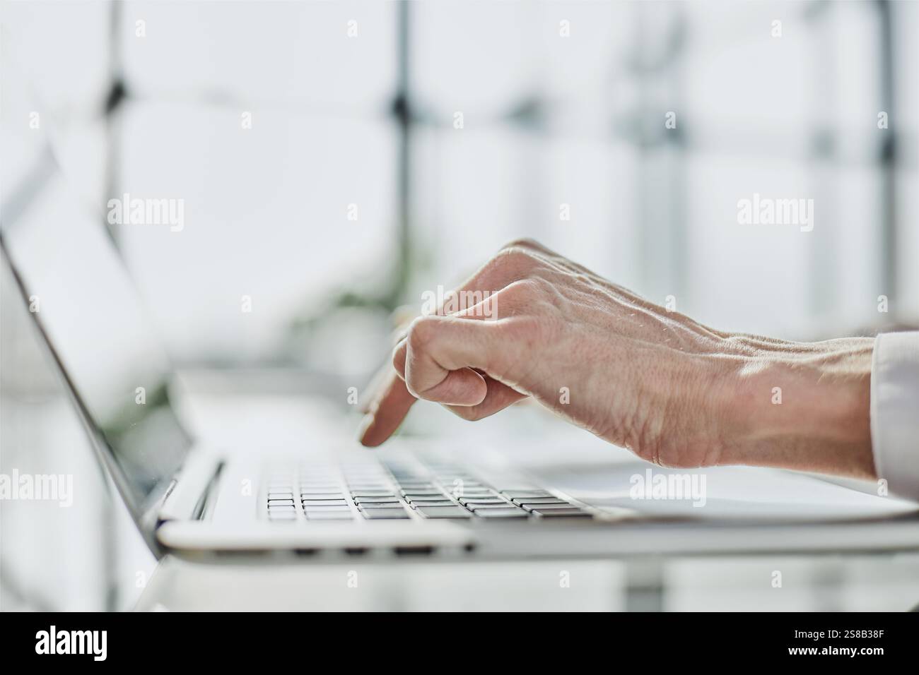 Pressing button on laptop computer. Side view female hands typing on ...