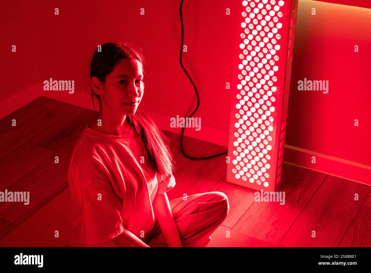 Close-up of a young woman during a red light therapy session indoors ...