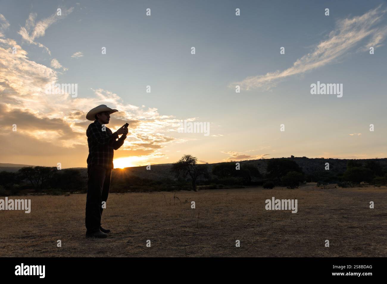 Vaquero Mexicano preparing for a day in the countryside at sunset Stock Photo
