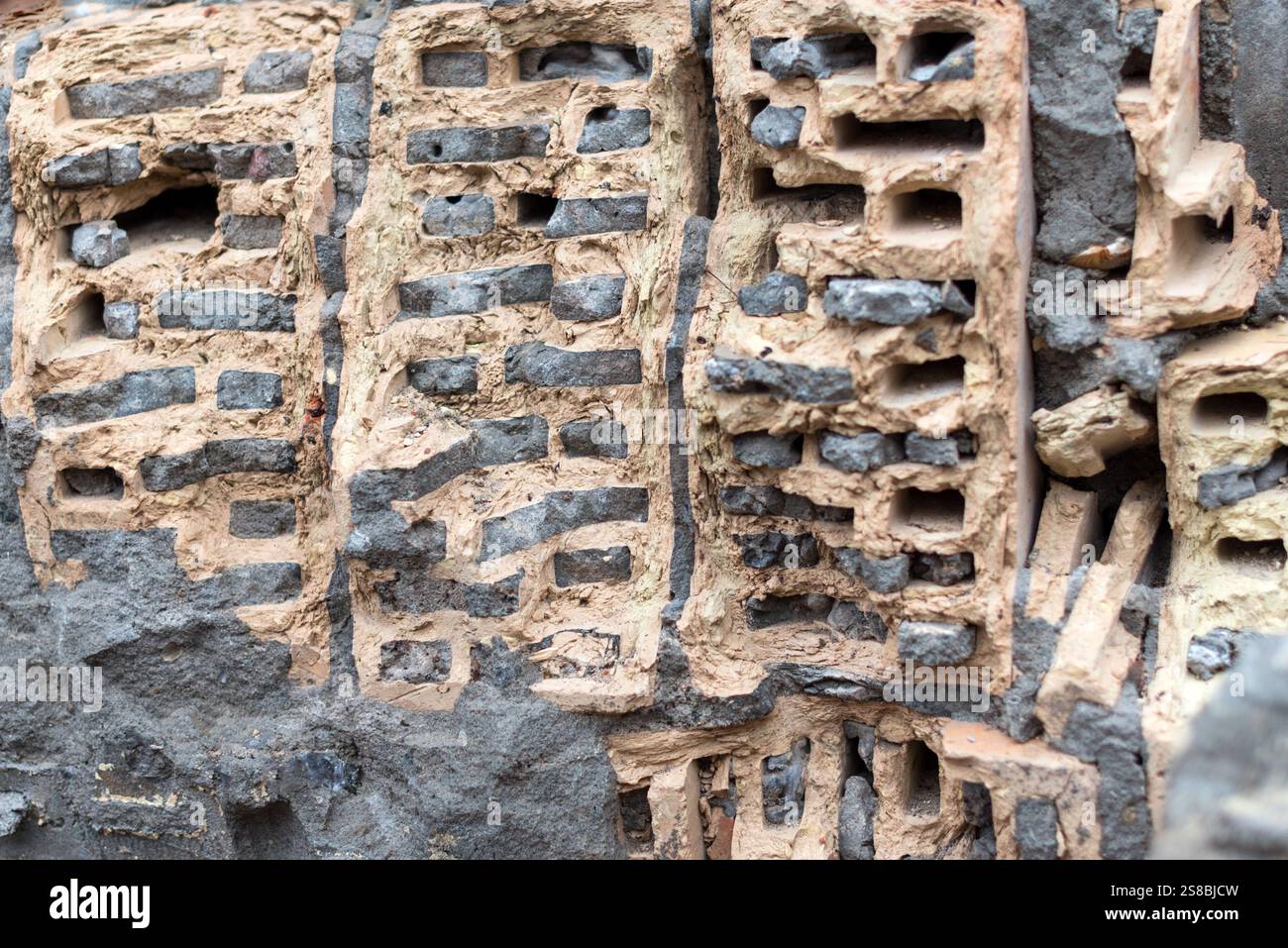 Rustic, weathered bricks embedded in concrete. The macro perspective ...