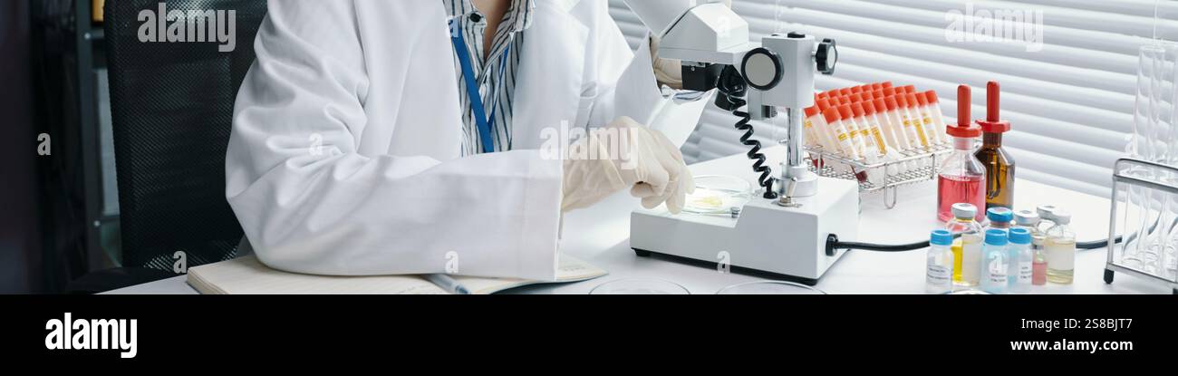 Scientist Working in Modern Laboratory with Microscope Stock Photo