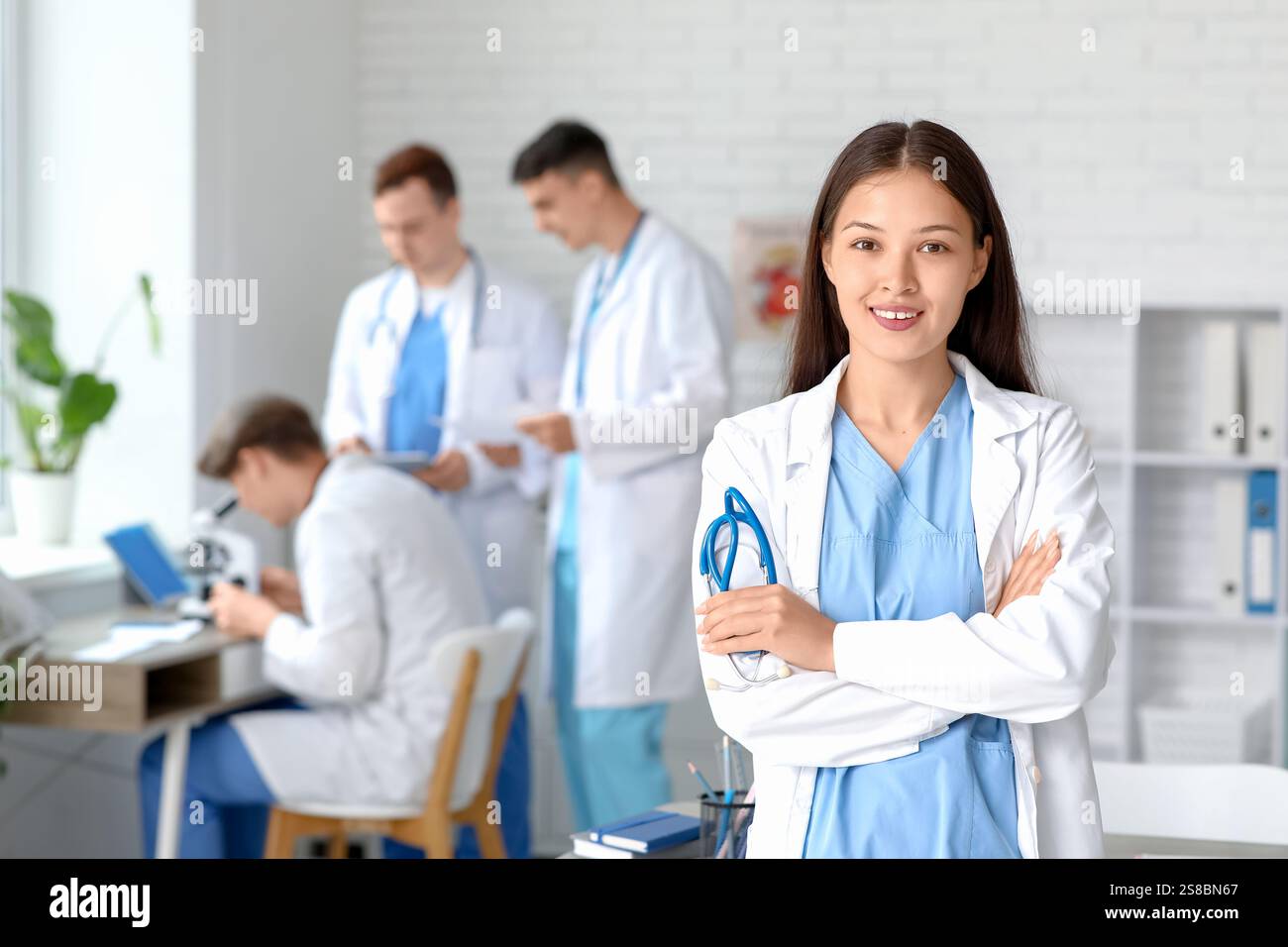 Female Asian doctor with stethoscope in clinic Stock Photo - Alamy