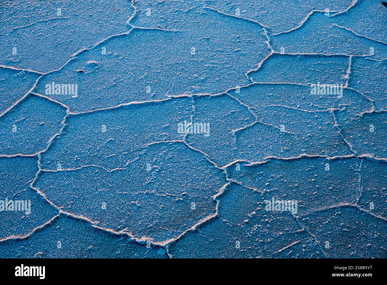 Natural Salt Pattern Cracked patterns of a blue salt flat surface resemble natural textures ...